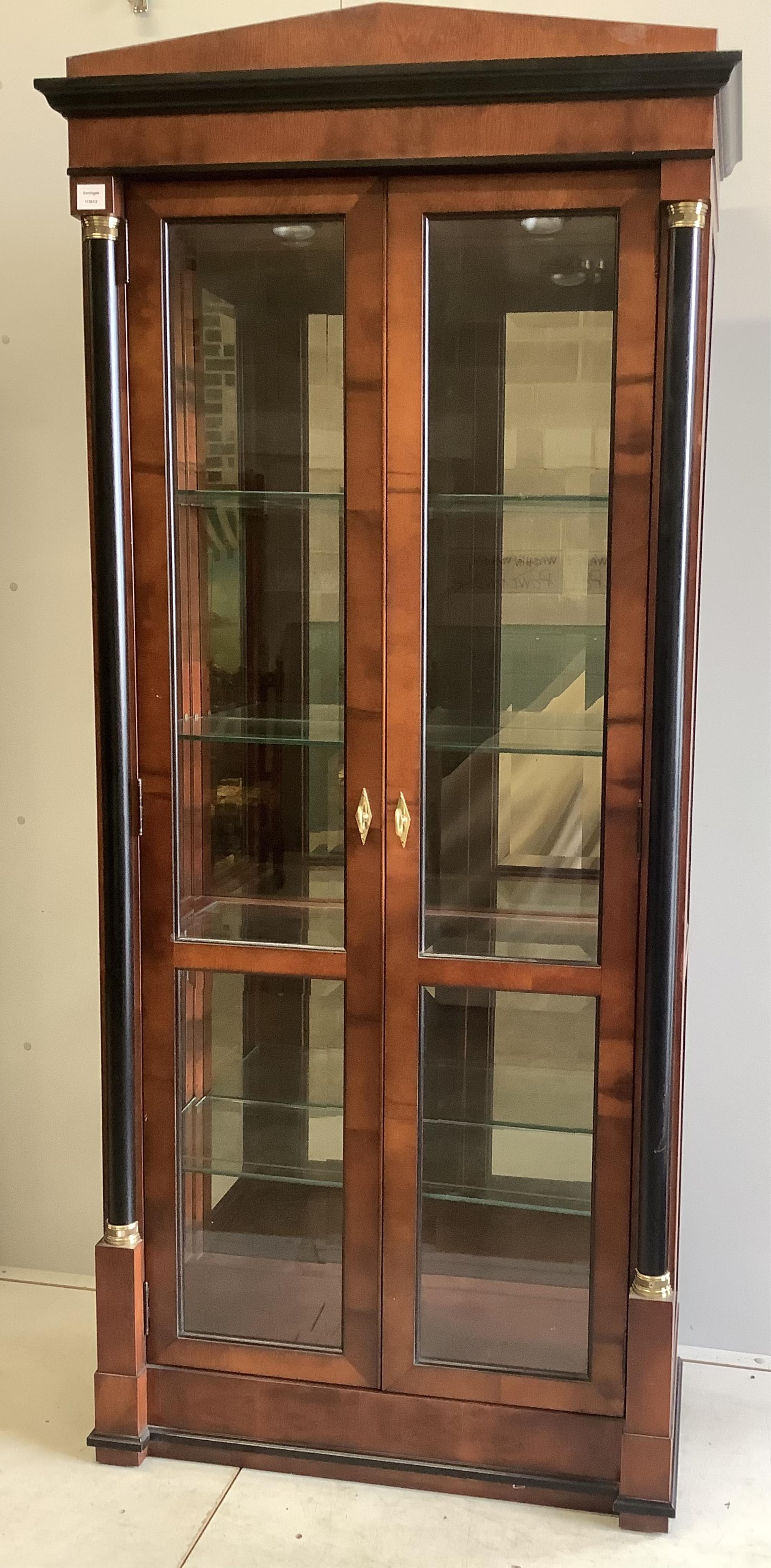 A pair of French Empire style mahogany and ebonised two door display cabinets, width 92cm, depth 42cm, height 210cm. Condition - good